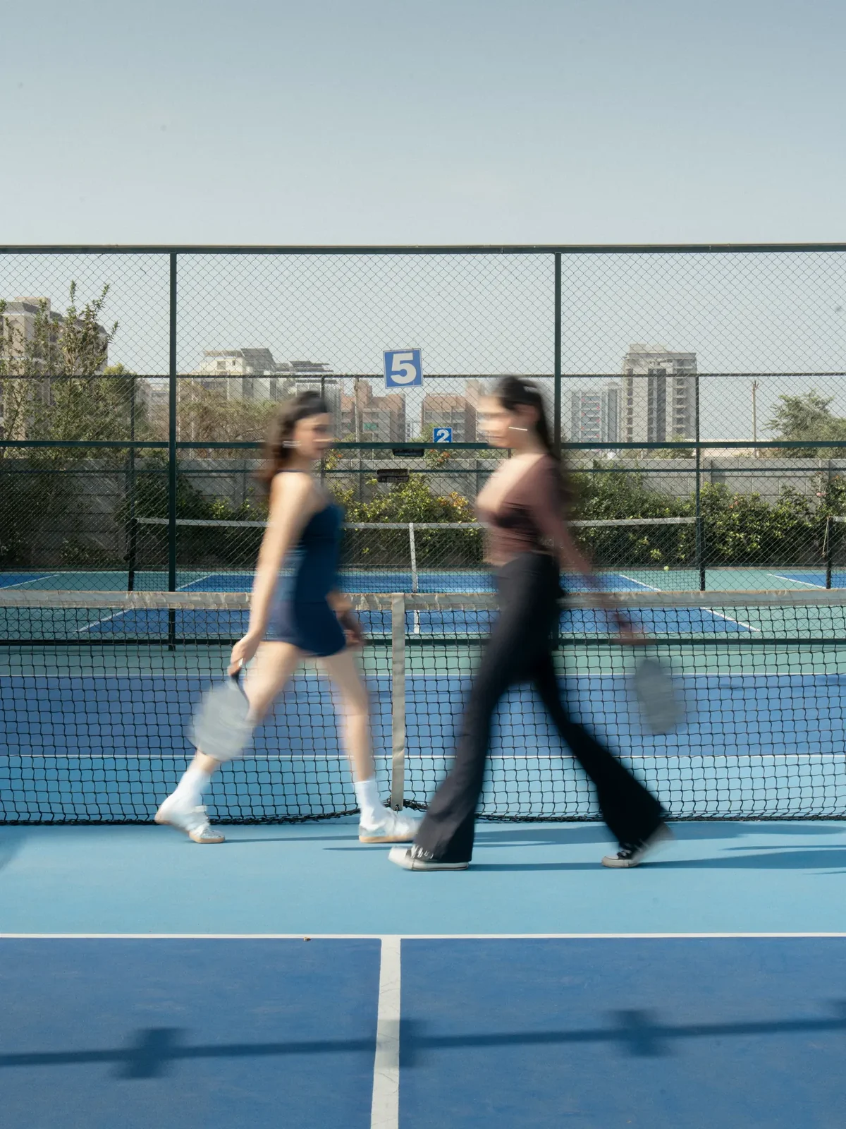 Two Ace Bounce players walking off the court together, paddles in hand